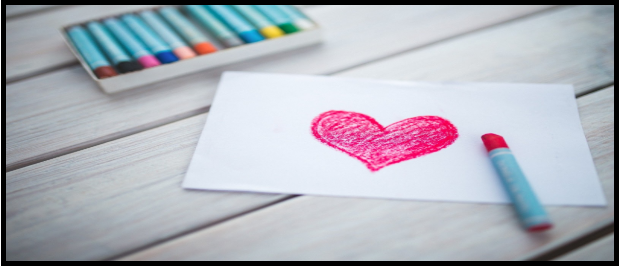 Pastel pink colored heart on a table to show how to teach through pictures